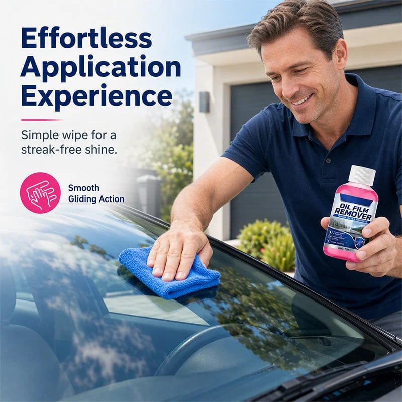 Man wiping a car windshield with a microfiber cleaning cloth